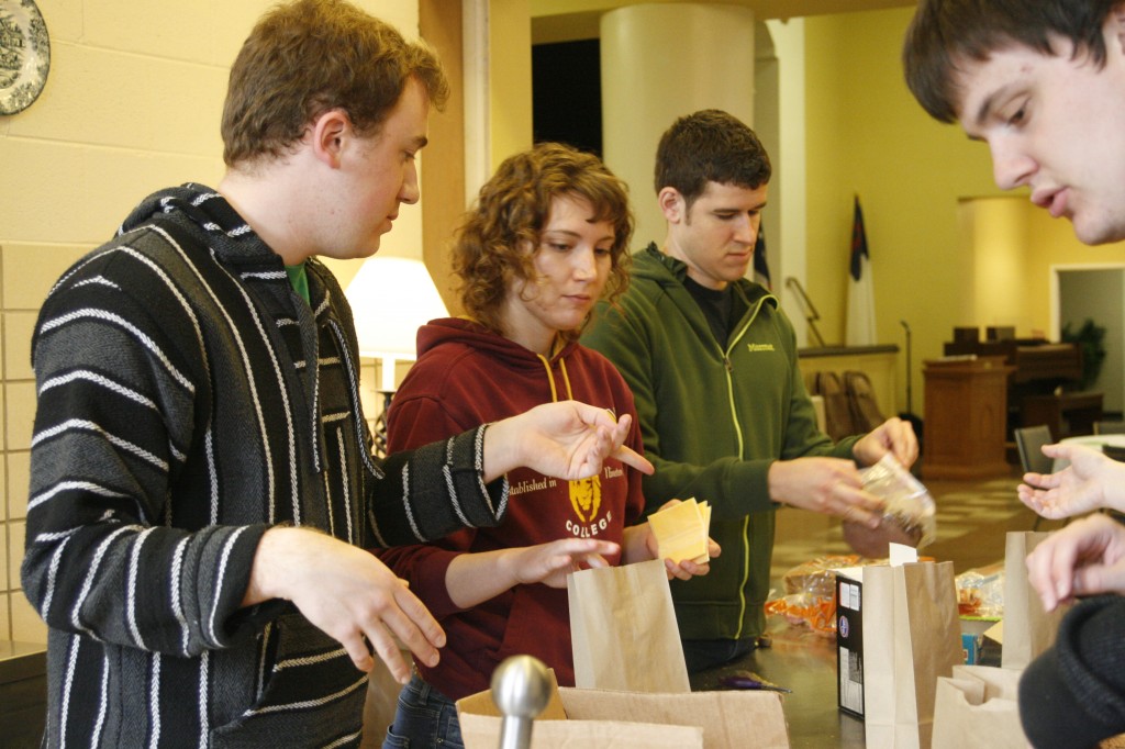 Left to Right, Jonathan Warner, senior, Starla Bivins, junior, Eric McEachron, assistant director for faith and missions, Brian Burnsed, junior, pack meals during their Break for Change trip to Atlanta over spring break. 