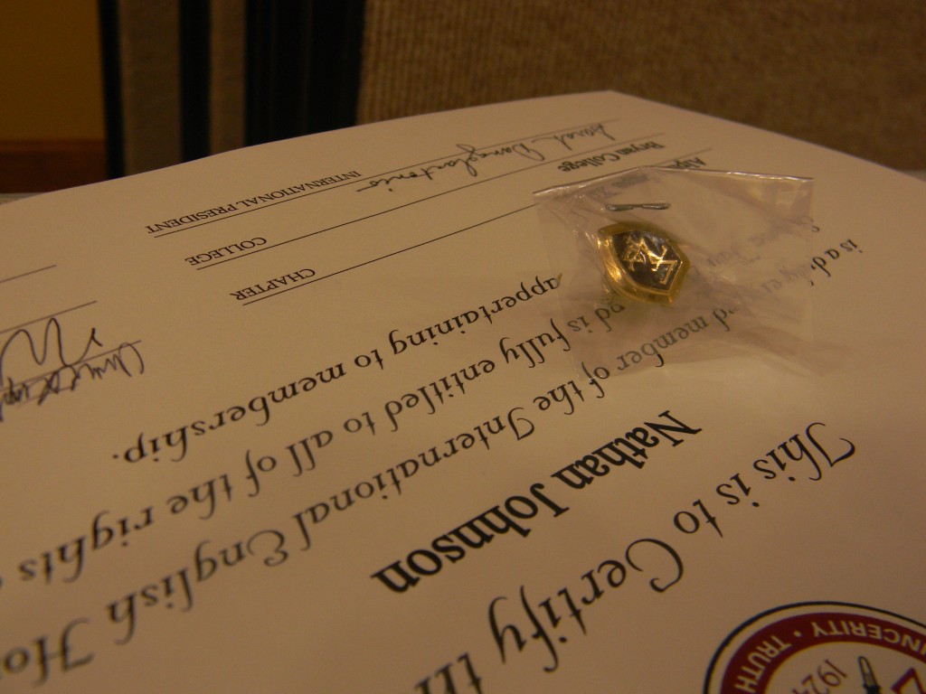 Every new member of the society received a certificate and a pin. When students graduate, they can add a chord to their graduation robes to mark their participation in the society. / Photo by Daniel Jackson 