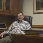 A former basketball coach and SWAT team member, Dr. Steven Livesay, president of Bryan College, sits at his desk in his office in Mercer.   